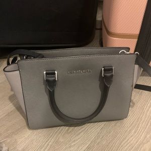 Michael Kors pocketbook; comes with a long strap